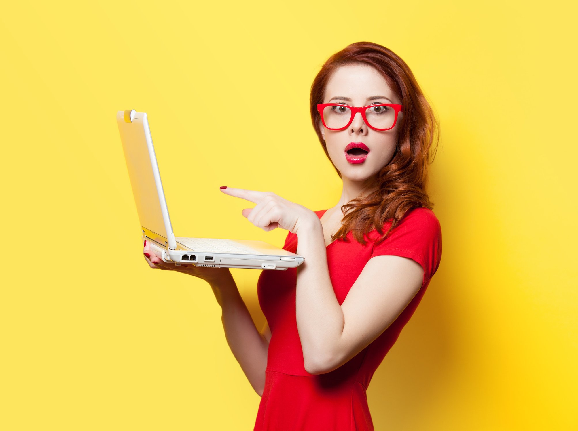 Surprised Redhead Girl with Laptop